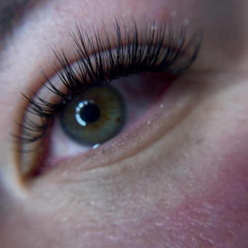 Close-up of volume lashes with green eye